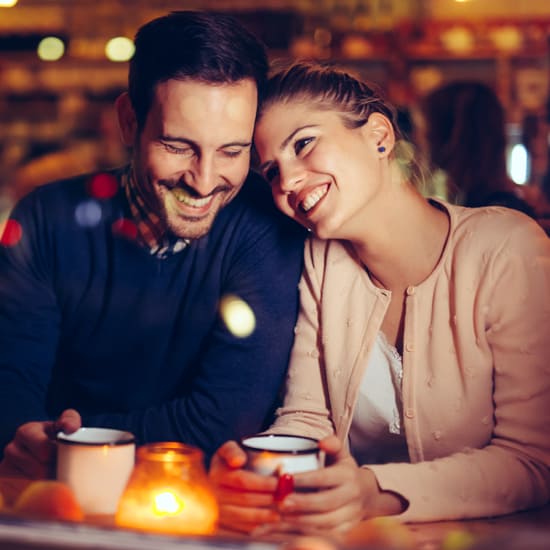 Couple having coffee with the candle lit